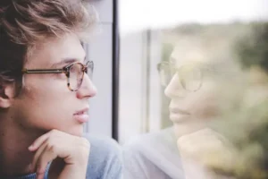 man looking out of window