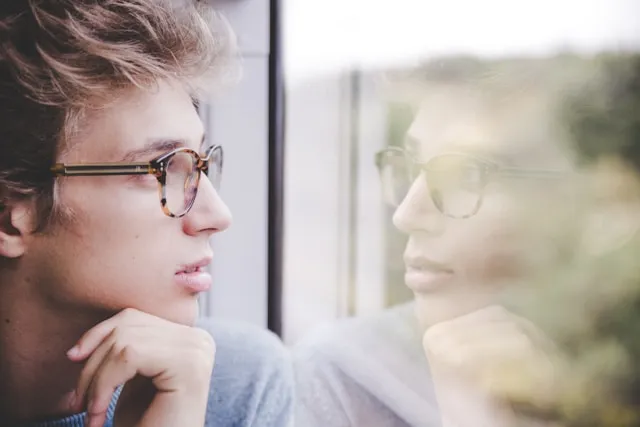 man looking out of window