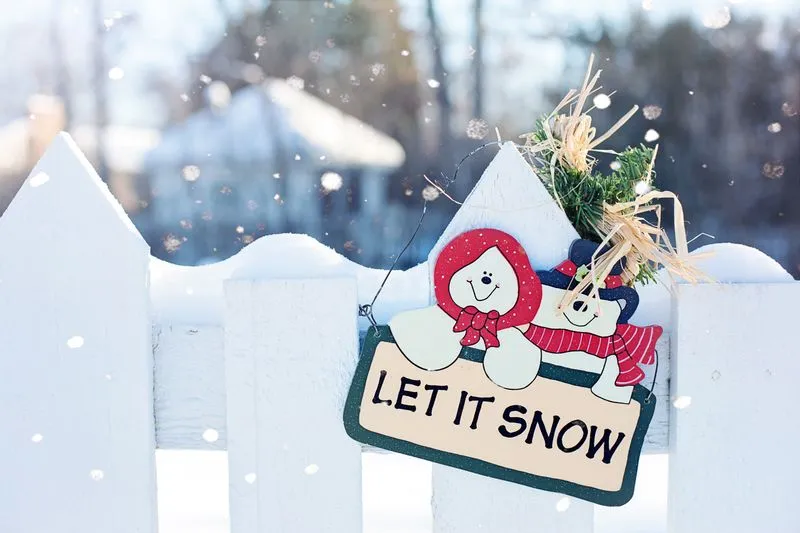 sign on snowy fence