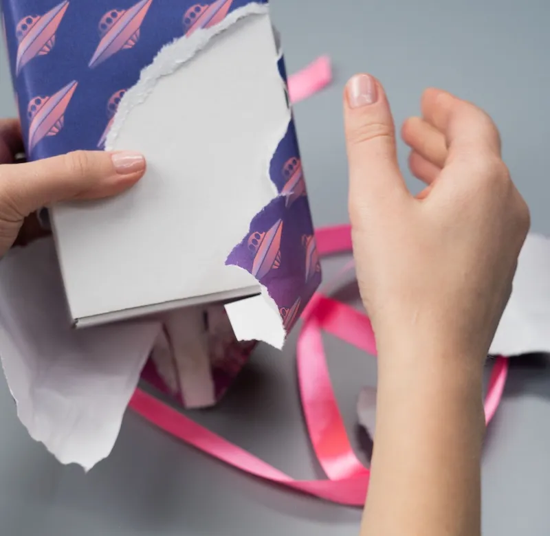 person unwrapping gift