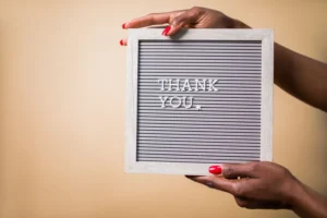 woman holding sign reading thank you