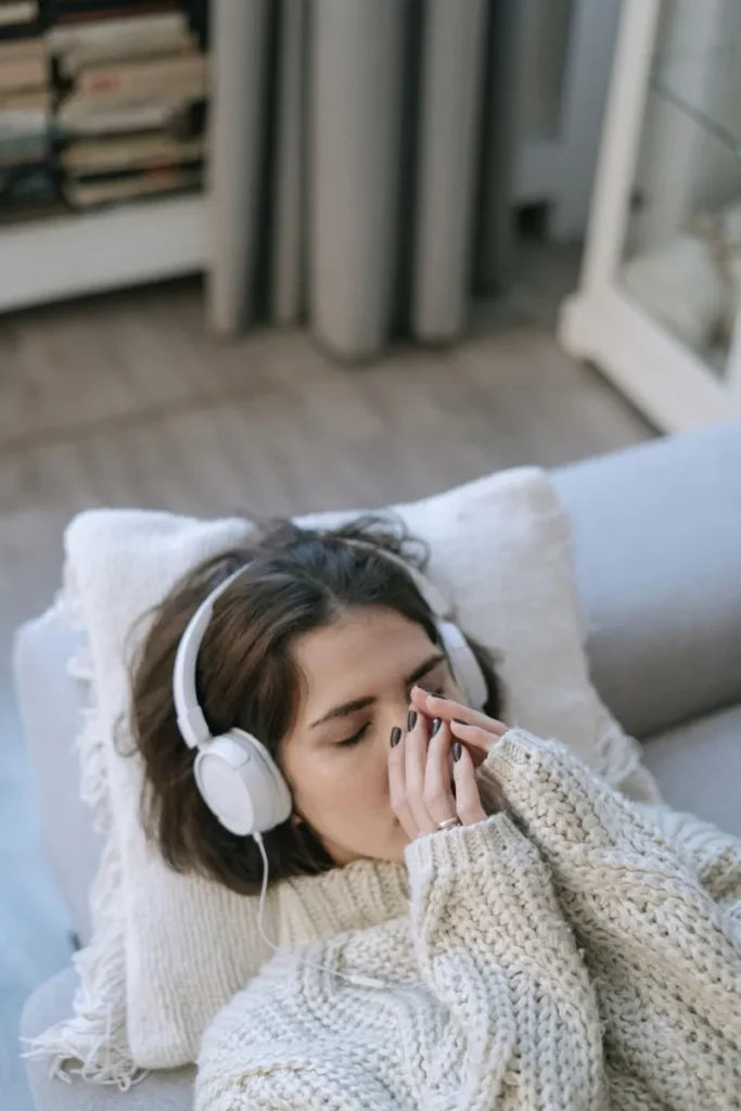 woman laying back with headphones on