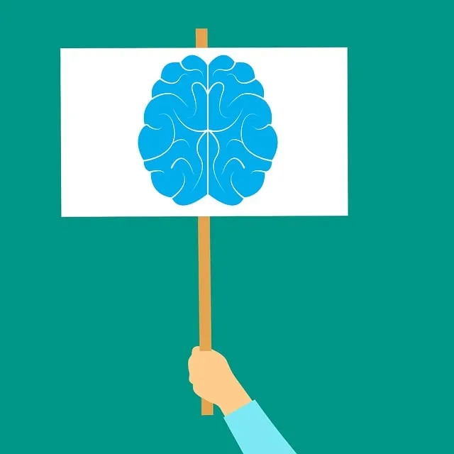 person holding up sign with brain drawing on it