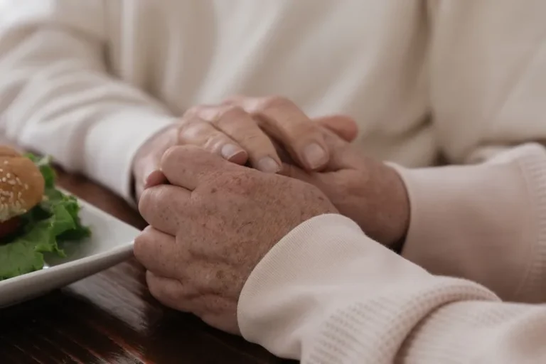 holding hands supportively over table