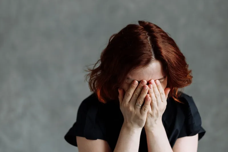 woman with head in hands