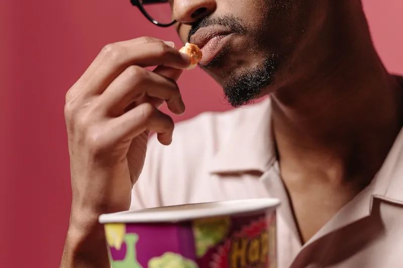 close up of person about to eat popcorn