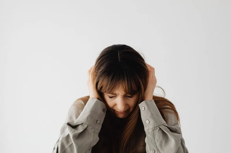 woman with hands over ears