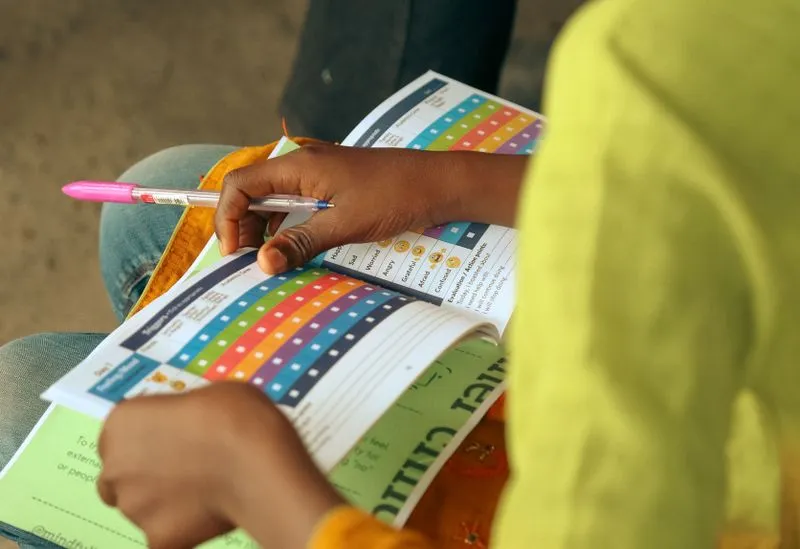 person filling out workbook