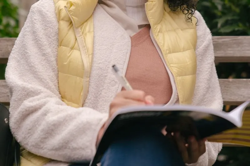 woman writing in workbook