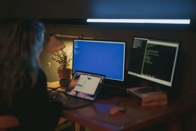person using blue light on computer screen at night