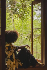 woman sitting in window