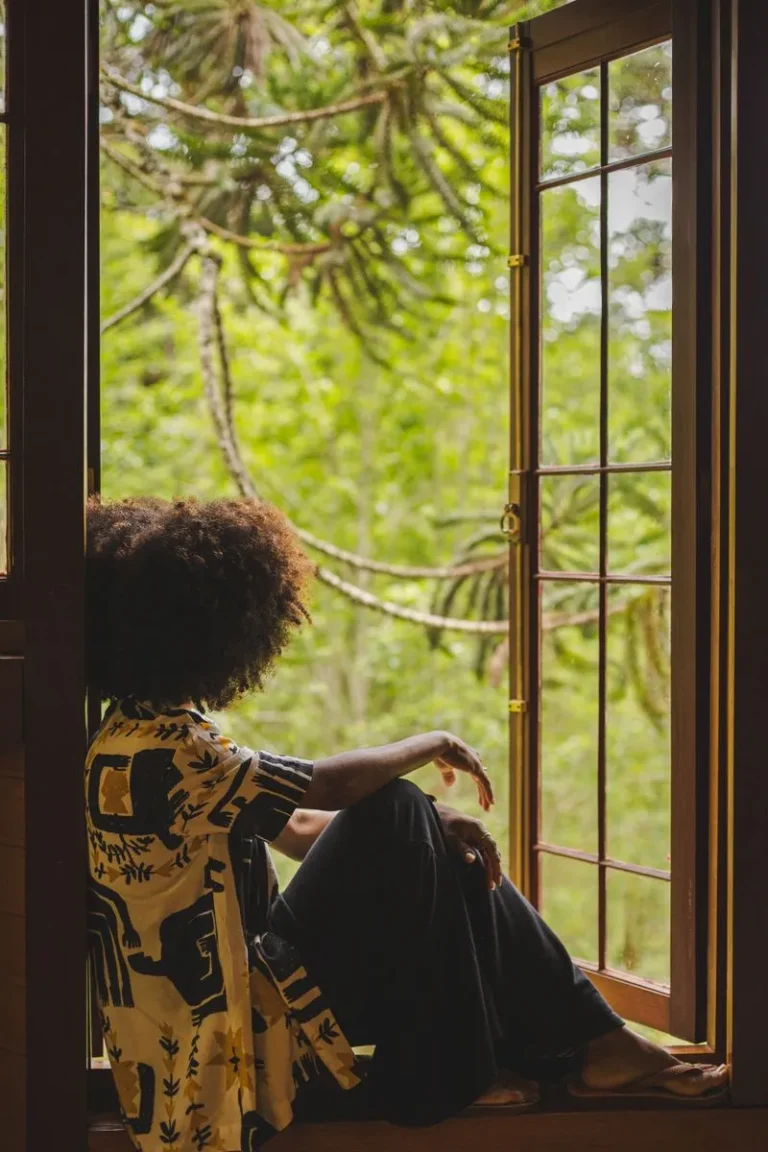 woman sitting in window
