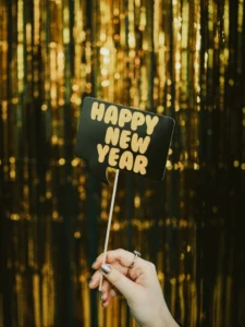new years sign in front of tinsel curtain