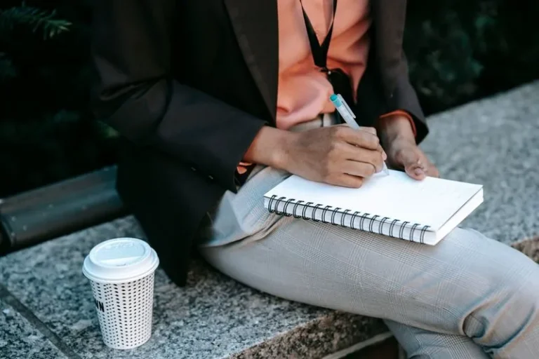 person writing in notebook