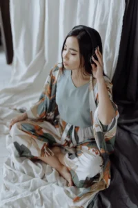 woman meditating with headphones on