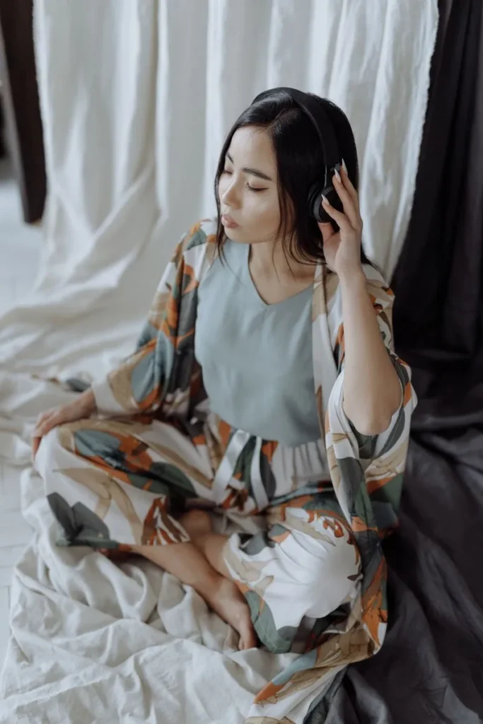 woman meditating with headphones on