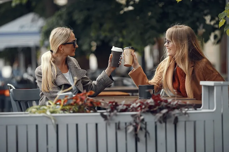 two friends having coffee together