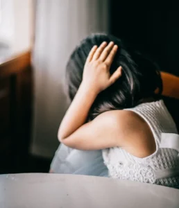 young girl covering ears