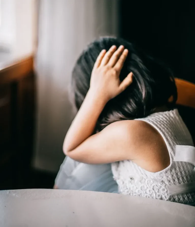 young girl covering ears