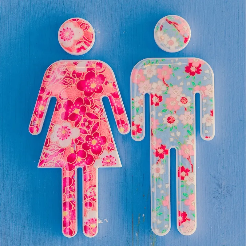 cut outs of woman and man shapes filled with flowers