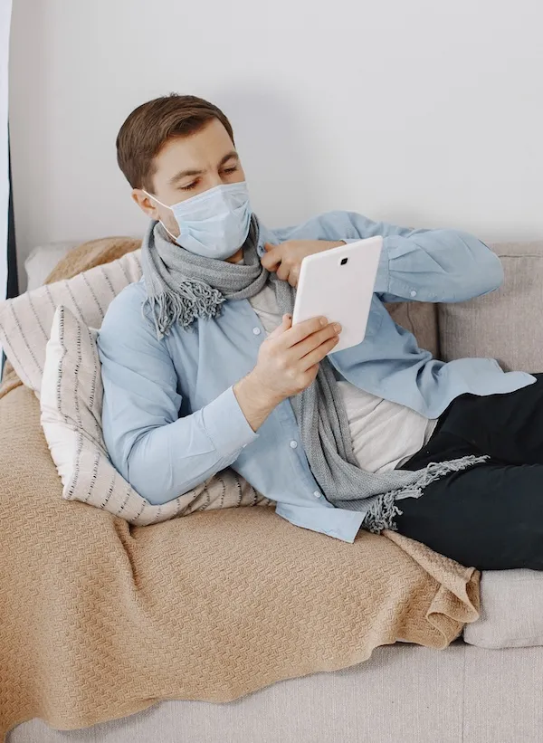 man on sofa in mask