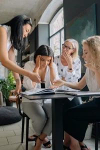 woman at work looking overwhelmed in group of colleagues