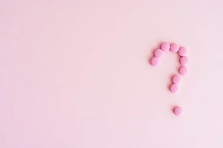 pink question mark made from pills