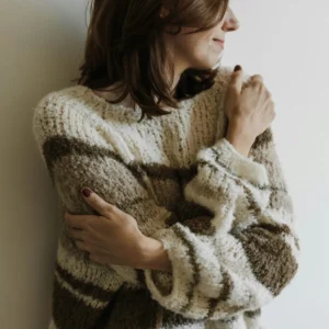 woman in knitted jumper hugging herself